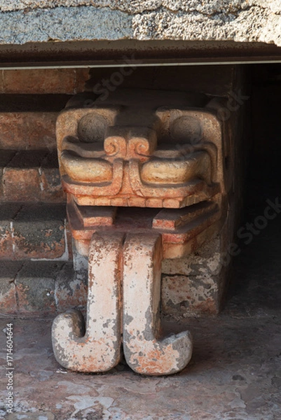 Fototapeta Teotihuacan, Mexico - 1 December 2022: Detailed snake head is the representation of the god Quetzalcoatl at the temple of the Feathered Serpent