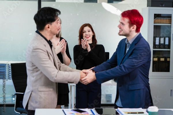Fototapeta Diverse business team collaborates in modern office, discussing charts, data, strategies. Their professional teamwork reflects communication, leadership, success, productive, innovation cooperation.