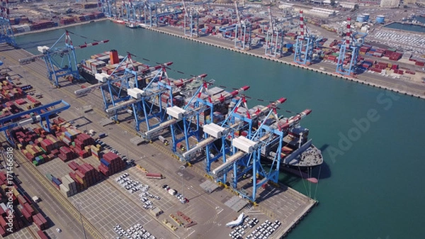 Obraz Fully loaded container ship docked at freight port terminal