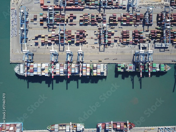 Obraz Fully loaded container ship docked at freight port terminal