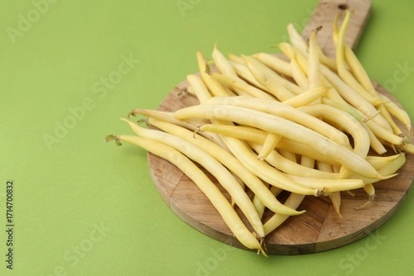 Fototapeta Fresh bean pods on green background, closeup. Space for text