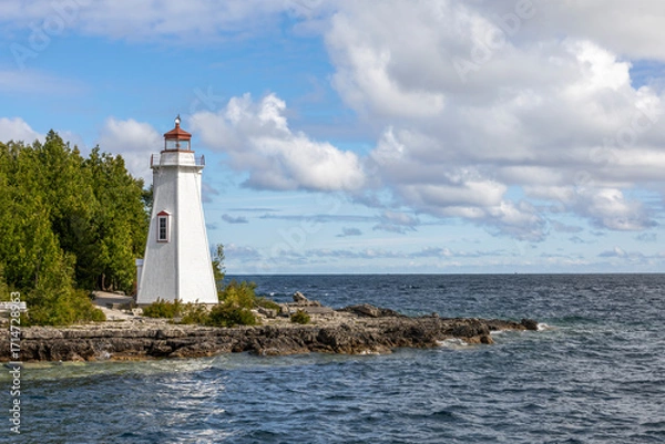 Obraz Big Tub Harbour Lighthouse stands tall in Tobermory, Ontario, overlooking the pristine waters of Georgian Bay.
