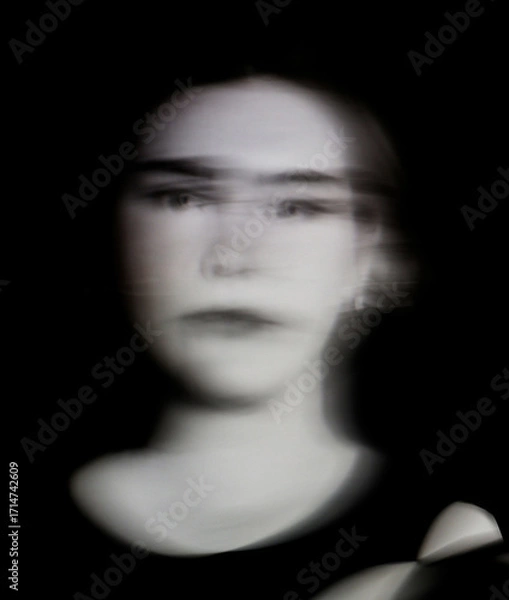 Fototapeta A beautiful young woman closeup with ICM motion blur effect abstract art in monochrome black and white