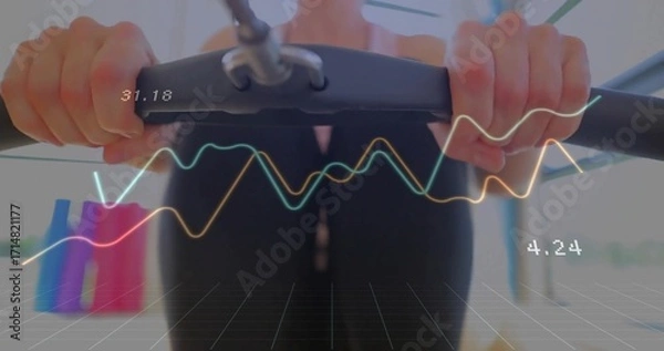Fototapeta Holding cardio handlebars, woman in black activewear exercising in gym, with digital metric overlay