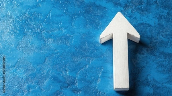 Fototapeta White arrow pointing up on blue textured background; growth concept