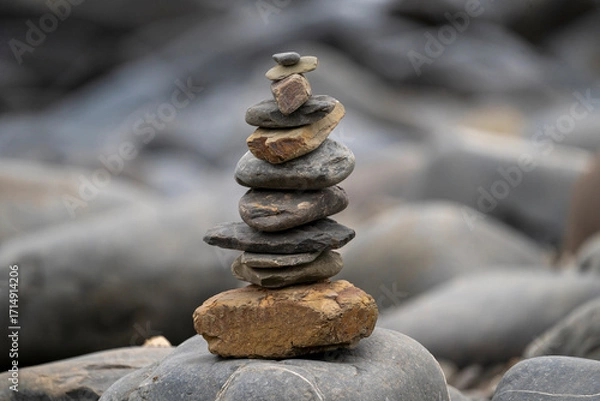 Fototapeta A calm rock balancing spot with stones and pebbles neatly stacked by a river in balance. A tranquil riverside or beach with rocks, Minimalist nature style