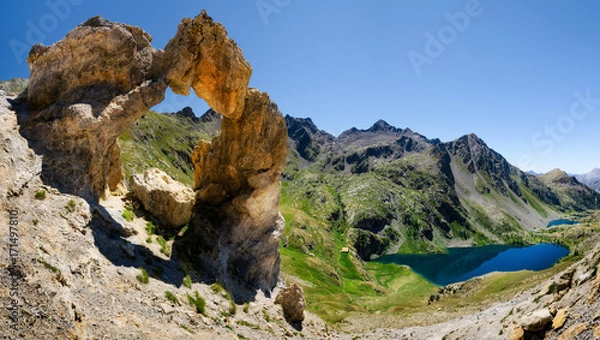 Fototapeta The famous Arc de Tortisse, natural arch in the national park of Mercantour (France) with the upper lake of Vens on the background