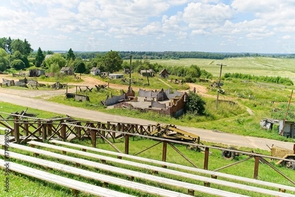 Fototapeta  Minsk region, Belarus, July 12, 2025. A field with a dilapidated fake village on the Stalin Line.                              