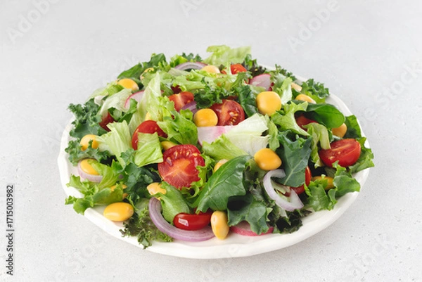 Fototapeta Green salad with fresh vegetables and lupine beans on white background. Vegetarian food.