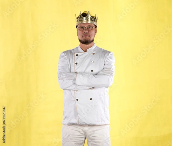 Fototapeta chef with a crown in a white suit on a yellow background