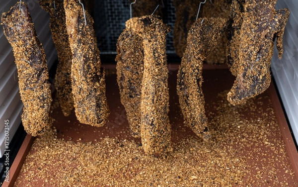 Fototapeta Close up of Beef Biltong Drying in Dehydrator
