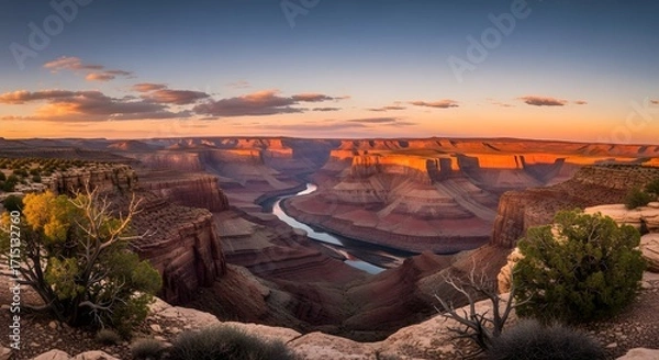 Fototapeta Majestic Canyon at Sunset: Captivating panoramic view of a vast canyon at sunset, displaying layers of geological formations, where the warm colors of the setting sun paint the landscape
