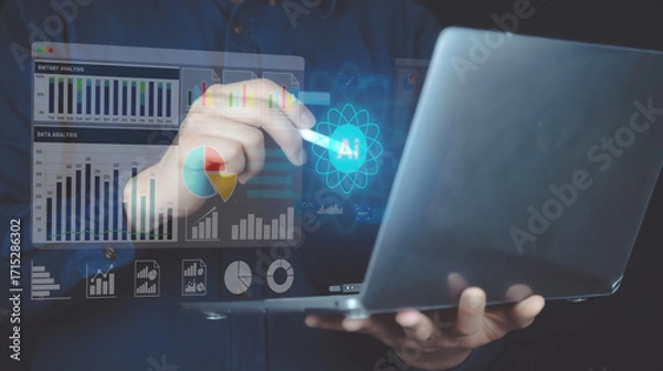 Fototapeta Businessman interacting with digital graphs and data visualization on holographic interface using a laptop computer.
