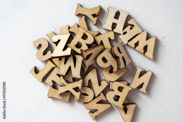 Fototapeta Wooden Alphabet Letters in a Random Pile on a Light Background