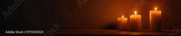 Fototapeta Warm, flickering candlelight illuminates a dark room, casting dancing shadows on the wall  Perfect for ambiance, relaxation, or romantic themes  Cozy and inviting atmosphere ,  peace,  warm