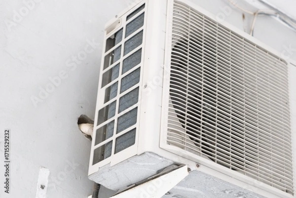 Fototapeta Close-up image of an outdoor air conditioning unit attached to a building wall