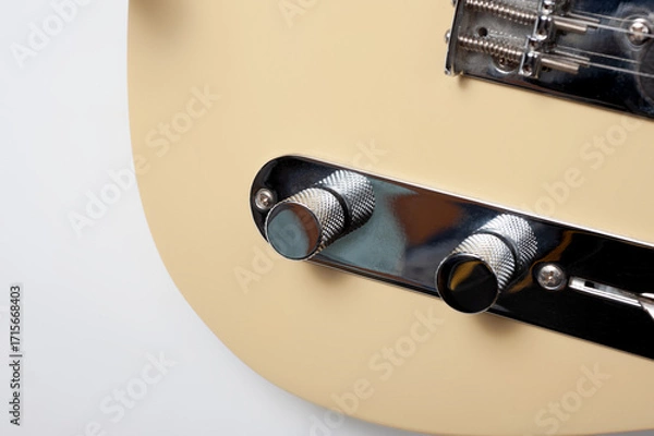 Fototapeta Six-string electric guitar, with a cream-colored wooden body and chrome-plated fittings.