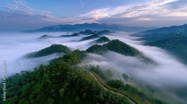 Fototapeta Majestic Mountain Landscape Surrounded by Serene Fog Under a Colorful Sunset Sky