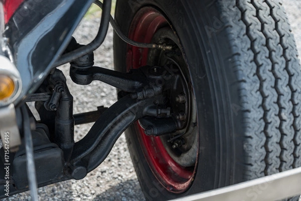 Fototapeta A detailed, close-up shot of the front axle, drum brake, and suspension components on a classic AA or BB truck