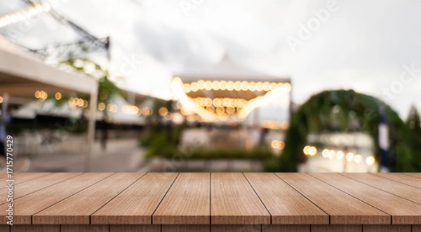 Fototapeta Empty wooden table top with lights bokeh on blur restaurant background.	