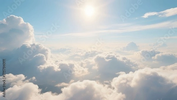Fototapeta Aerial view of fluffy white clouds under bright sunlight in a clear blue sky