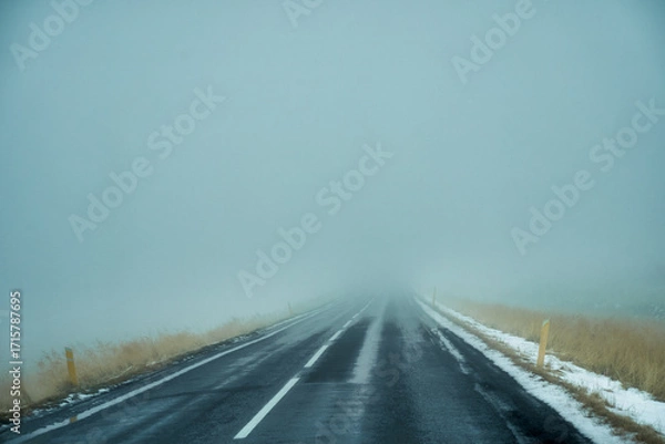 Fototapeta Heavy mist on the road for road trip in Icelnad travel , unpredict weather for travel.