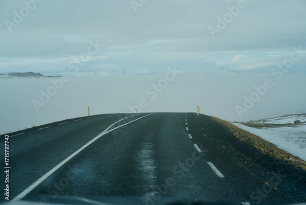 Fototapeta Road trip in Iceland with heavy mist in front of a car , driving travel to collect the northern light of Iceland.