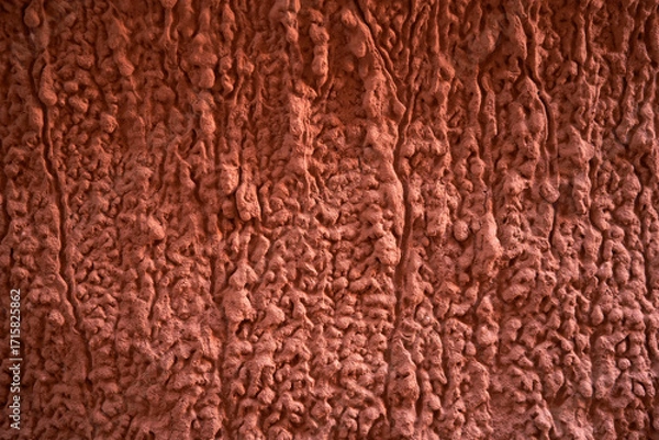 Obraz A Textured Red Wall Surface Featuring Unique and Intriguing Patterns
