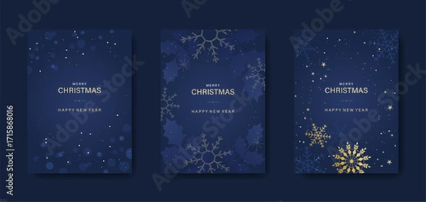 Fototapeta Merry Christmas and Happy New Year! Greeting card or invitation template featuring holly and golden snowflakes on a blue background.