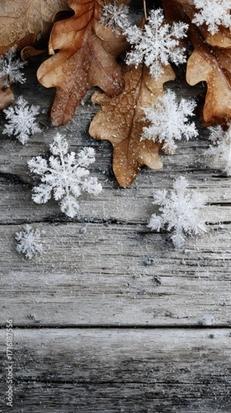 Fototapeta Minimalist vertical image of snowflake clusters and dry leaves on raw wooden planks, no text or logo