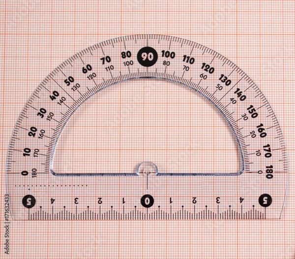 Fototapeta Close-up of a protractor on  graph paper