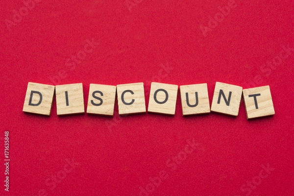 Fototapeta Discount word on scrabble wooden tiles isolated on red background