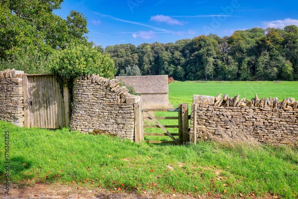 Fototapeta The historic and picturesque village of Bibury, in the Cotswolds, Gloucestershire, England, famous for its medieval stone houses