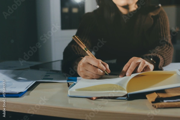 Obraz Close-up of businessman's hands making notes, mobiles, chart, desk, office