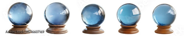 Fototapeta Five blue crystal balls are resting on wooden stands, casting a soft reflection on transparent background