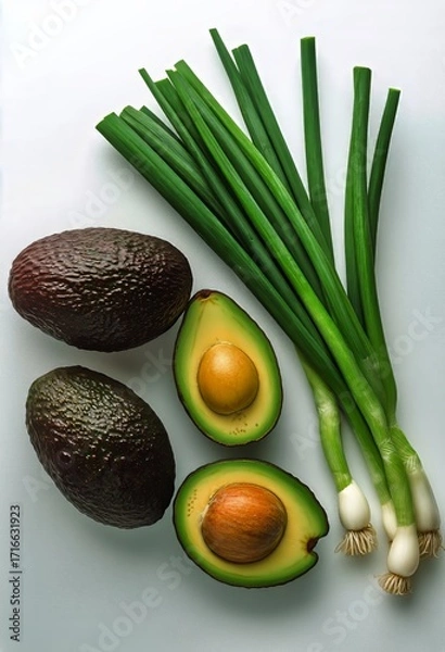 Fototapeta Fresh Avocado and Green Onions Arranged on a Light Background for Healthy Cooking Ideas.