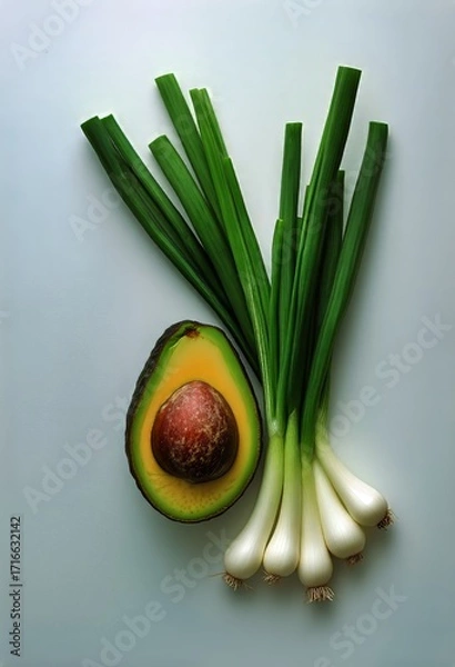 Fototapeta Fresh Avocado and Green Onions Arranged on a Light Background for Healthy Cooking Ideas