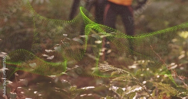 Fototapeta Floating neon green digital mesh wave weaving above forest floor, with ferns, leaves, hiking boots