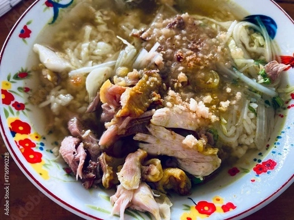 Fototapeta close up of a bowl of soto ayam with chicken meat and savoury broth