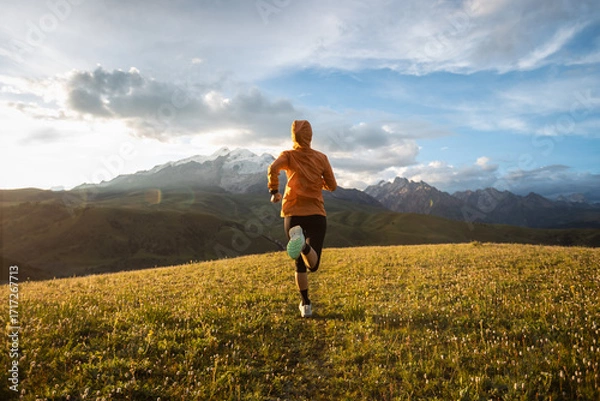 Fototapeta Trail runner running on the high altitude grassland mountain top