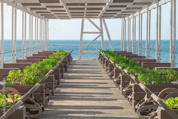 Fototapeta Scenic Ocean View From a Wooden Boardwalk With Comfortable Seating
