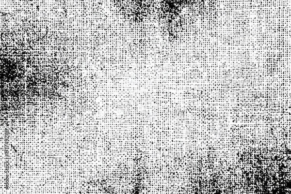 Fototapeta Abstract textured grayscale image of a fabric or canvas.  A blend of black and white dots and lines create a mottled effect, emphasizing the weave