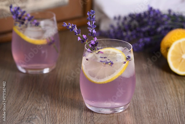 Fototapeta Summer homemade lemonade with lavender syrup, lemon juice and sparkling water with lavender sprigs
