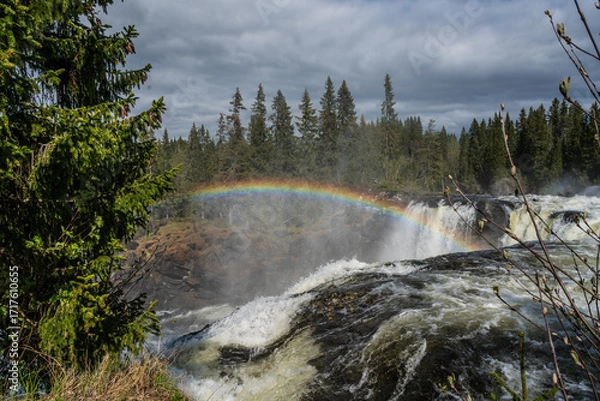 Fototapeta Ristafallet Waterfall in Sweden with a rainbow in the sky.