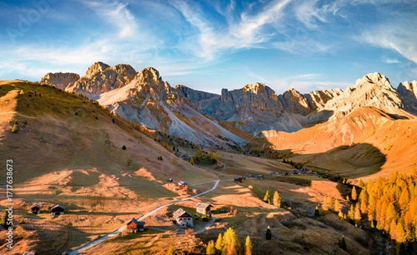 Fototapeta Colorful autumn scene of Fuchiade valley. Fantastic morning view of Dolomite Alps, Italy, Europe. View from flying drone of golden larch trees forest. Beauty of nature concept background.