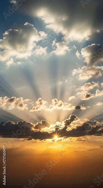 Fototapeta A breathtaking sunset view with golden rays piercing through dramatic clouds, showcasing a serene and peaceful atmosphere.