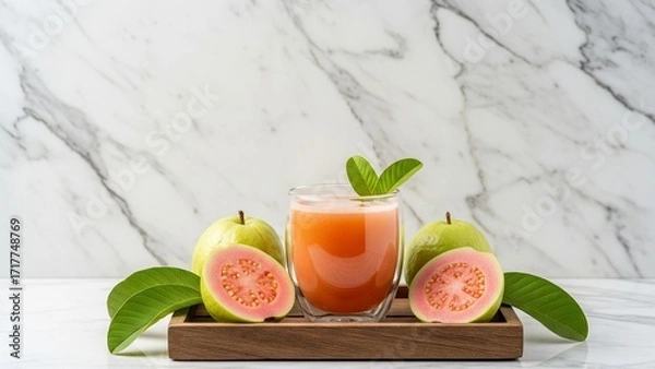 Fototapeta Guava juice in a glass on a tray with a marble background
