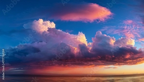 Fototapeta enchanting colorful sky with fluffy clouds blending together creating a vivid display of colors at twilight
