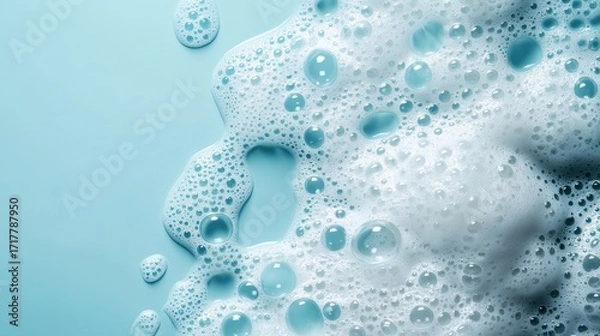 Fototapeta Soft, frothy bubbles against a light blue background, creating a calming and fresh aesthetic, ideal for cleaning or bathing contexts.