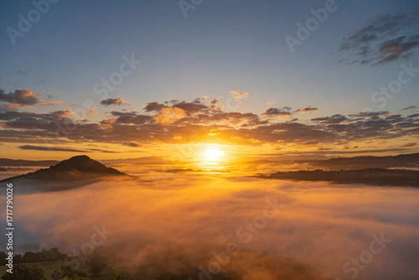 Fototapeta The most beautiful warm sunrise above auvergne montain with orange fog valey